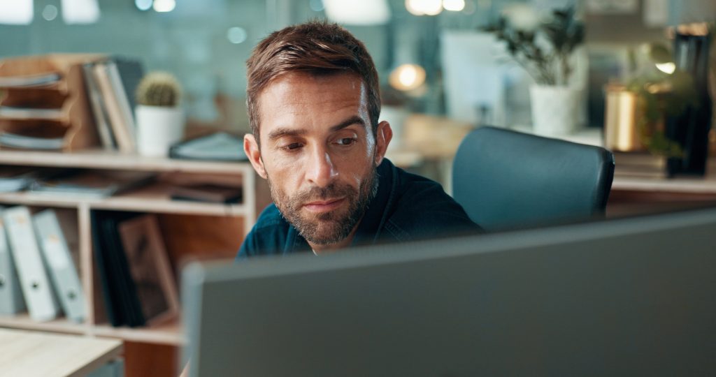 Research, journalism or man on computer in office for editor feedback, news publication or article review. Business, night or journalist at media press agency for story check, editing or proofreading