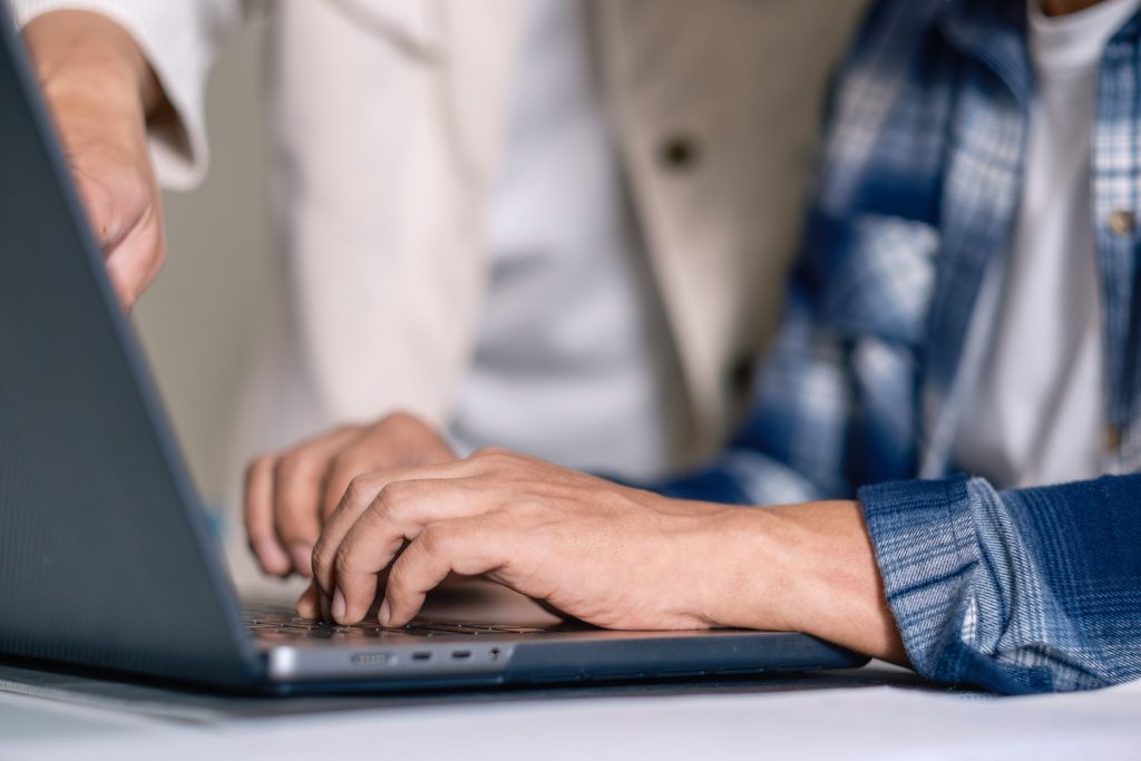 Senior male participating in a computer programming bootcamp, im